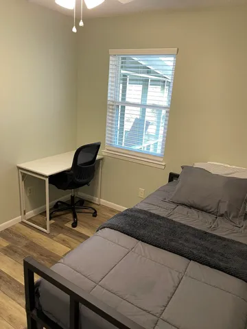 a bedroom with a bed and a window