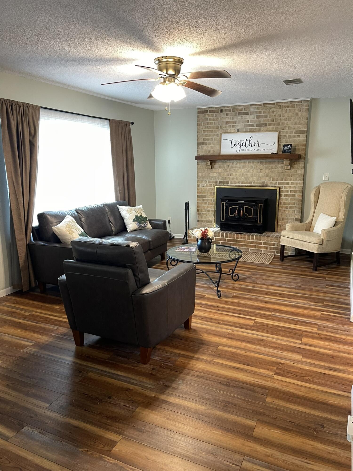 1086 County Highway 183 North DeFuniak Springs, FL 32433 - Photo 2 of 20 a living room with furniture and a fireplace