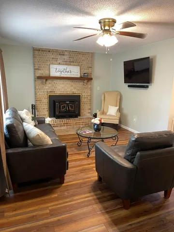 a living room with furniture and a fireplace