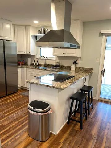 a kitchen with a stove a sink and a refrigerator