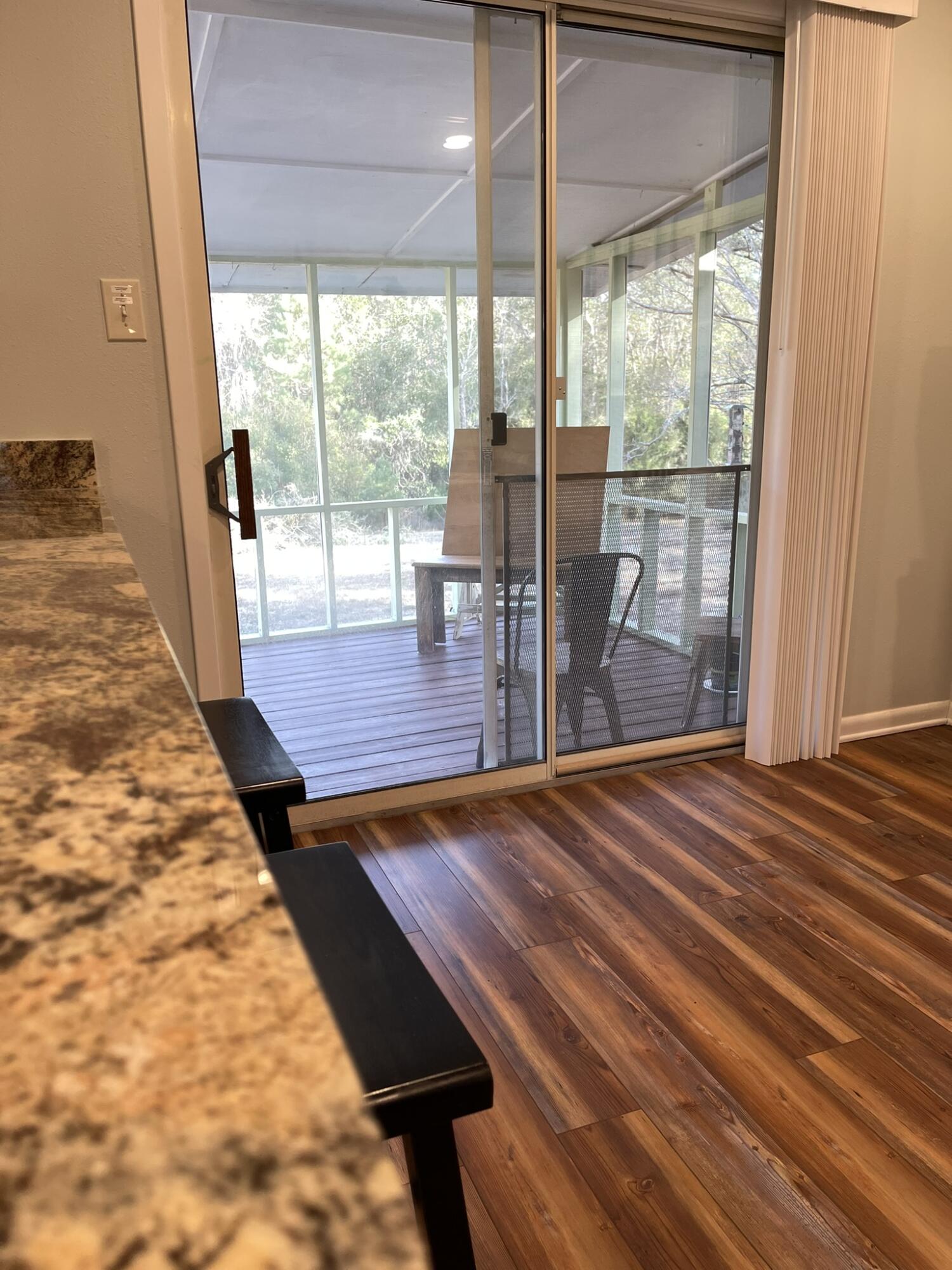 1086 County Highway 183 North DeFuniak Springs, FL 32433 - Photo 5 of 20 a room with wooden floor and a bed