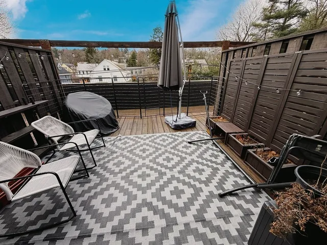 a balcony with table and chairs