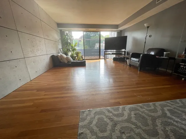 a view of a livingroom with furniture and a flat screen tv