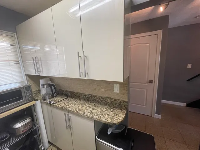 a kitchen with a stove and a refrigerator