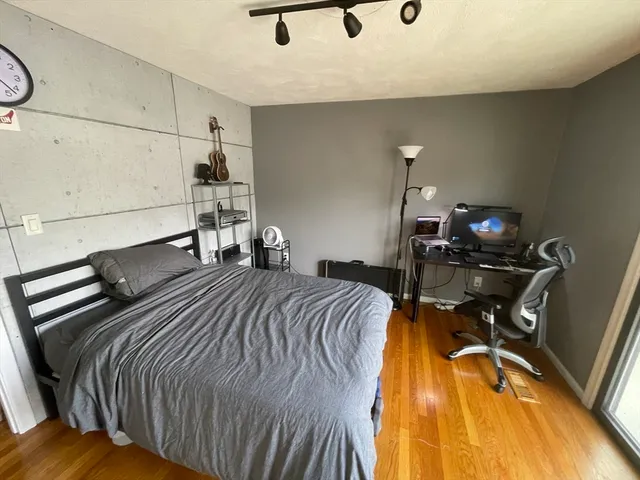 a bed sitting in a bedroom and chair