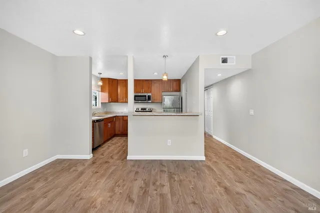 a kitchen with stainless steel appliances a sink a stove a refrigerator and a microwave