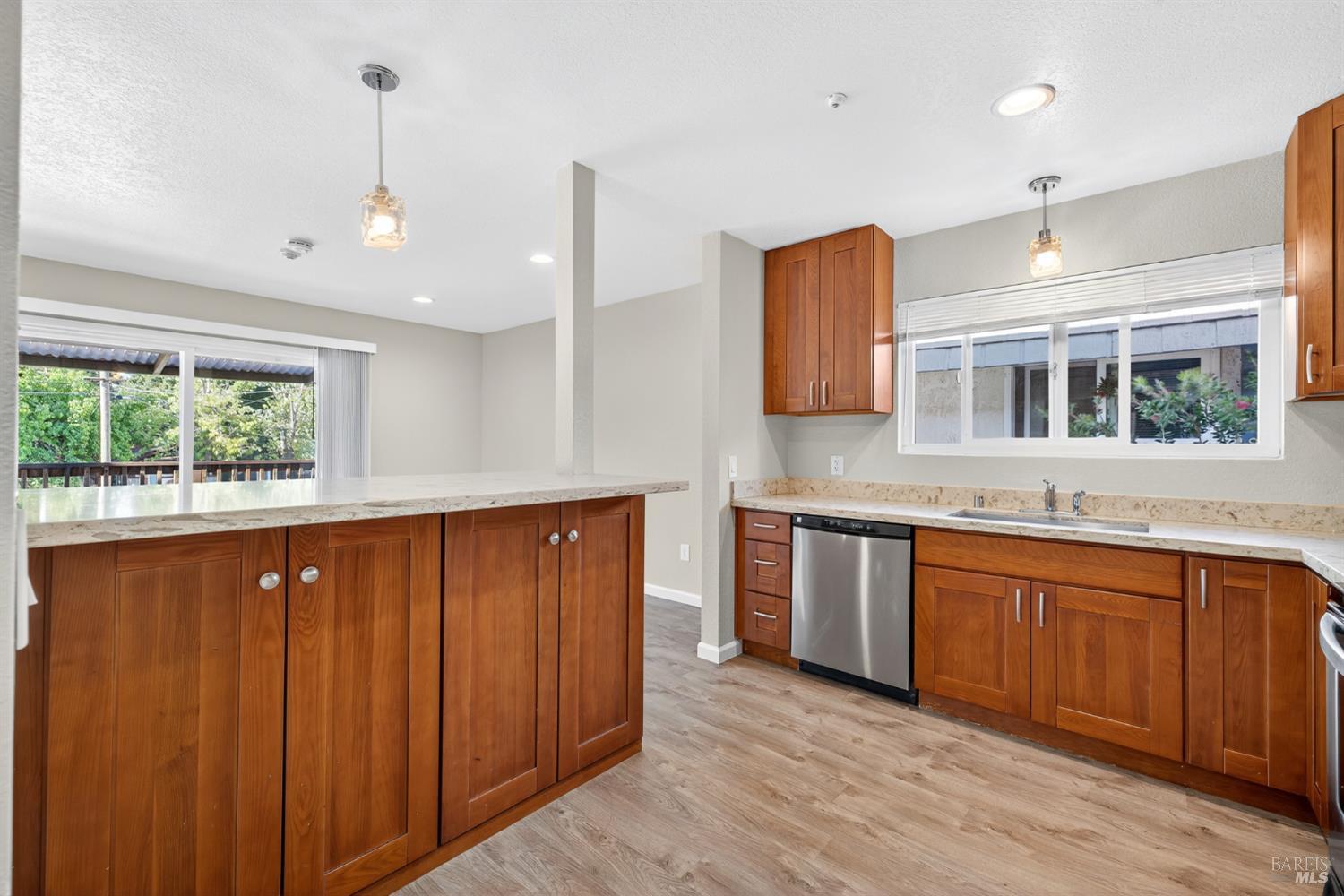 497 Sebastopol Avenue Santa Rosa, CA 95401 - Photo 13 of 42 a large kitchen with stainless steel appliances granite countertop wooden floors a sink and a large window