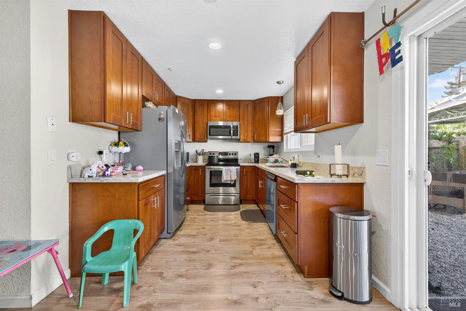 497 Sebastopol Avenue Santa Rosa, CA 95401 - Photo 15 of 42 a kitchen with stainless steel appliances granite countertop wooden cabinets a sink dishwasher and a refrigerator