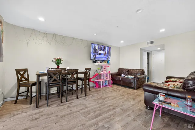 a living room with lots of furniture and a wooden floor