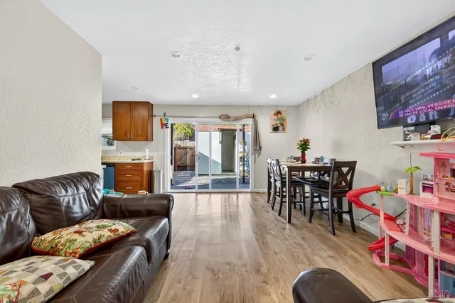 a living room with furniture a flat screen tv and a fireplace