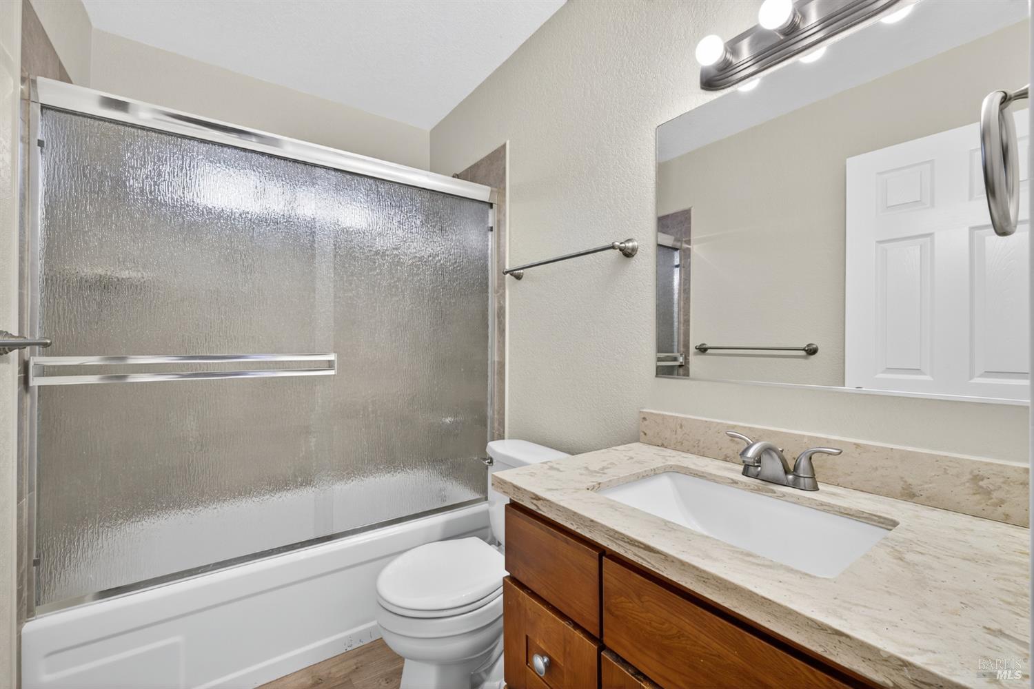 497 Sebastopol Avenue Santa Rosa, CA 95401 - Photo 5 of 42 a bathroom with a granite countertop sink toilet and shower