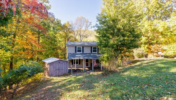 a view of a house with a backyard
