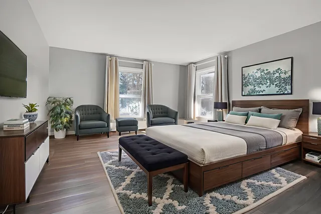 a bedroom with bed and a flat screen tv