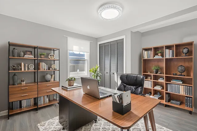 a living room with furniture a rug and a book shelf