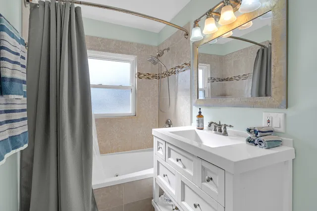 a bathroom with a sink double vanity and shower