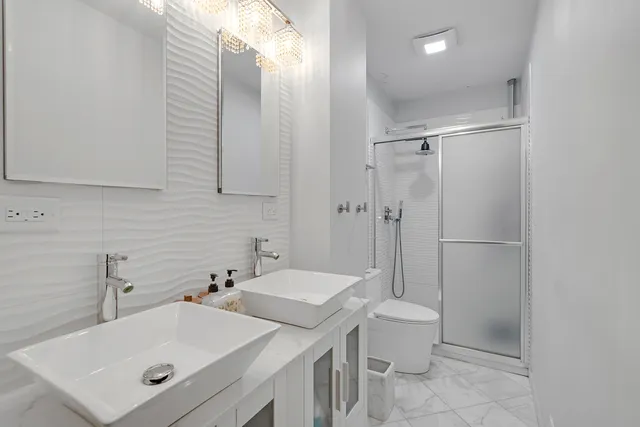 a bathroom with a sink toilet and shower