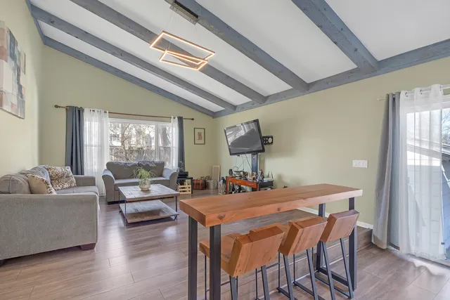 a dining room with furniture and wooden floor