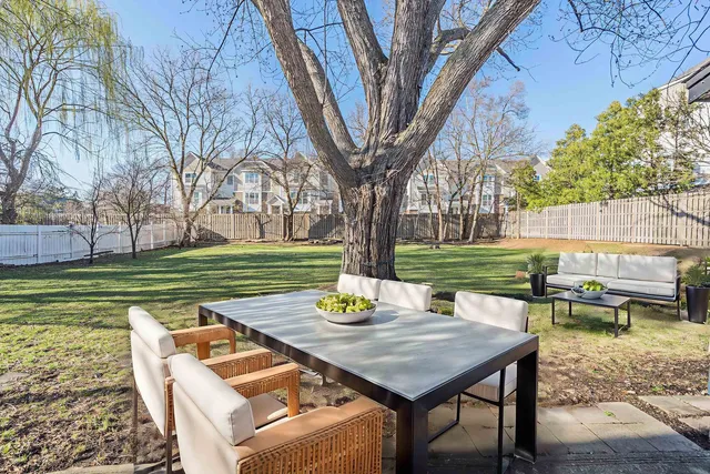 a view of a chairs and table in patio with a lake view