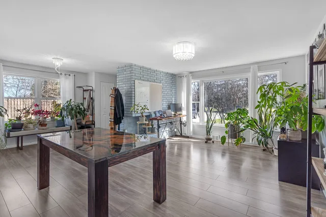 a dining room with furniture and wooden floor
