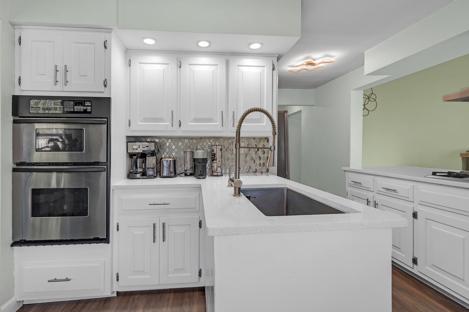 886 West Palatine Road Palatine, IL 60067 - Photo 7 of 27 a kitchen with white cabinets and stainless steel appliances