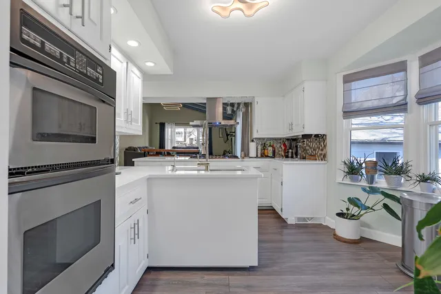 a kitchen with cabinets and wooden floor