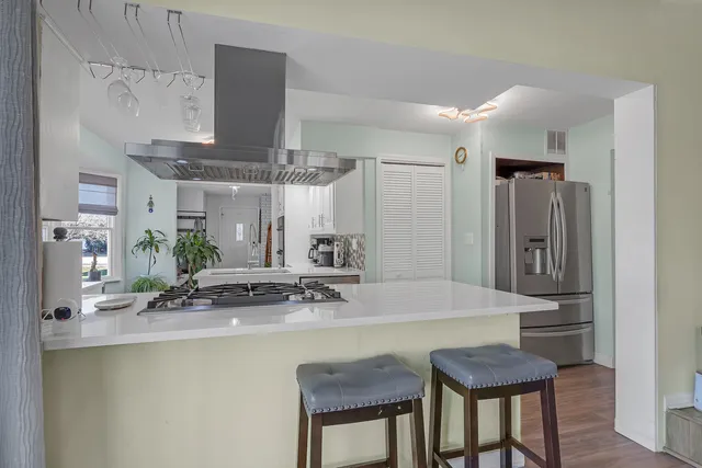 a kitchen with stainless steel appliances a sink and a refrigerator