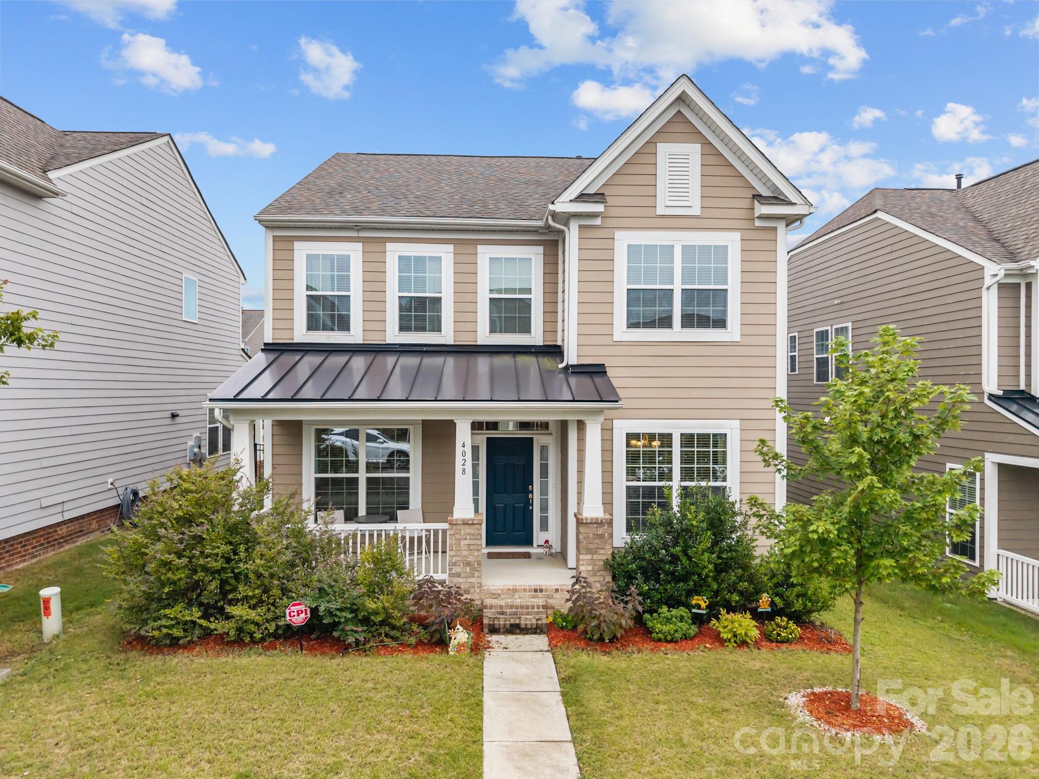 4028 Whittier Lane Tega Cay, SC 29708 - Photo 1 of 46 a front view of a house with a yard and potted plants