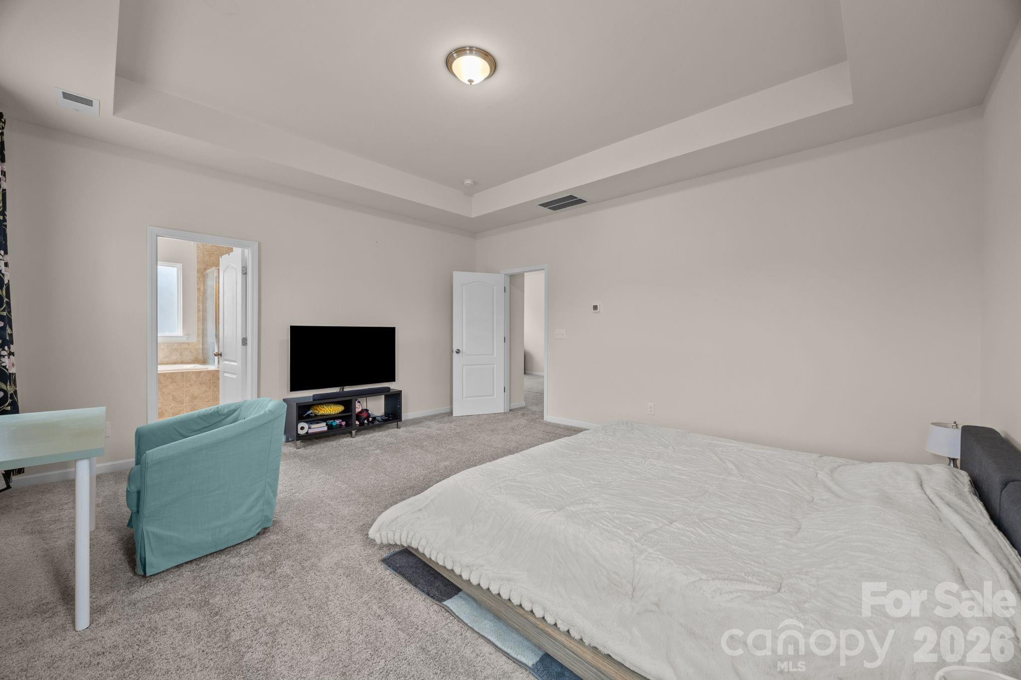 4028 Whittier Lane Tega Cay, SC 29708 - Photo 24 of 46 a bedroom with a bed and a flat screen tv
