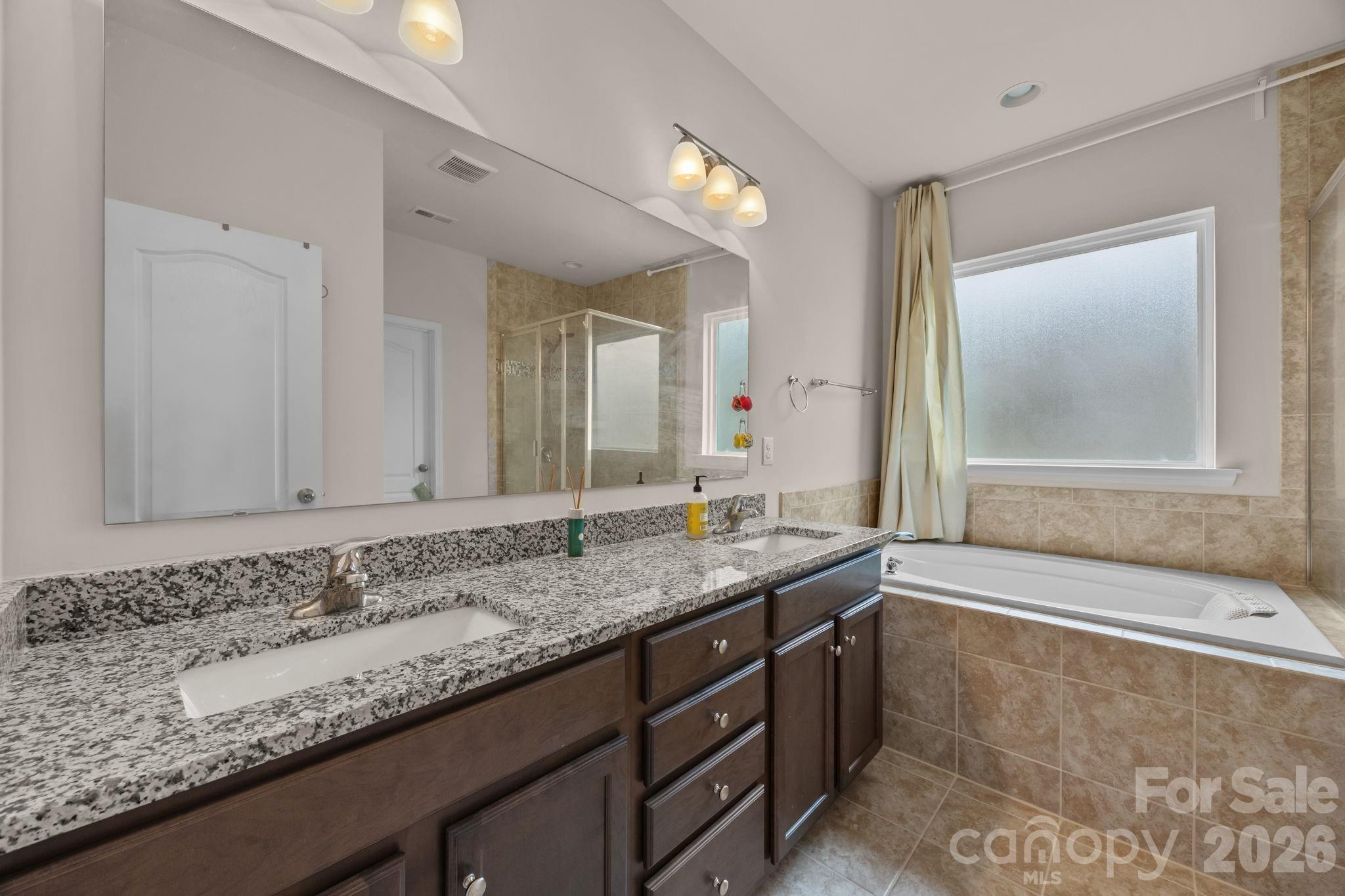 4028 Whittier Lane Tega Cay, SC 29708 - Photo 25 of 46 a bathroom with a granite countertop sink and a mirror
