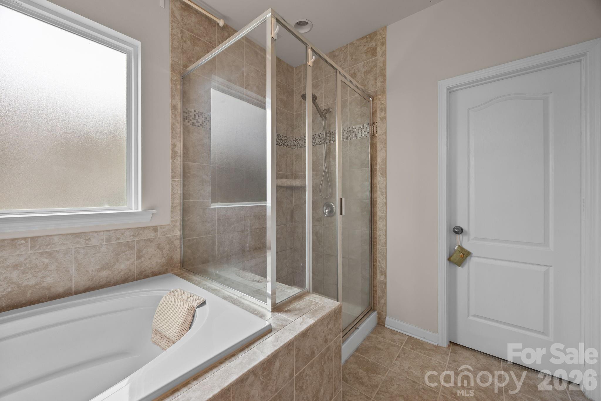 4028 Whittier Lane Tega Cay, SC 29708 - Photo 26 of 46 a bathroom with a tub and shower