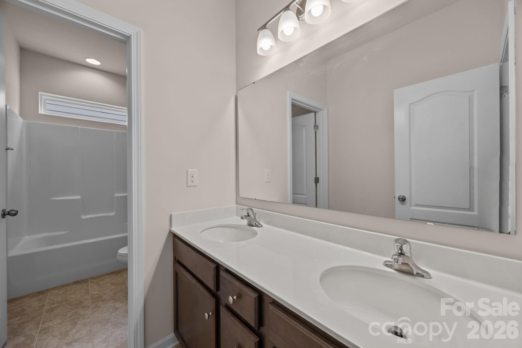 4028 Whittier Lane Tega Cay, SC 29708 - Photo 27 of 46 a bathroom with a sink double vanity and a mirror