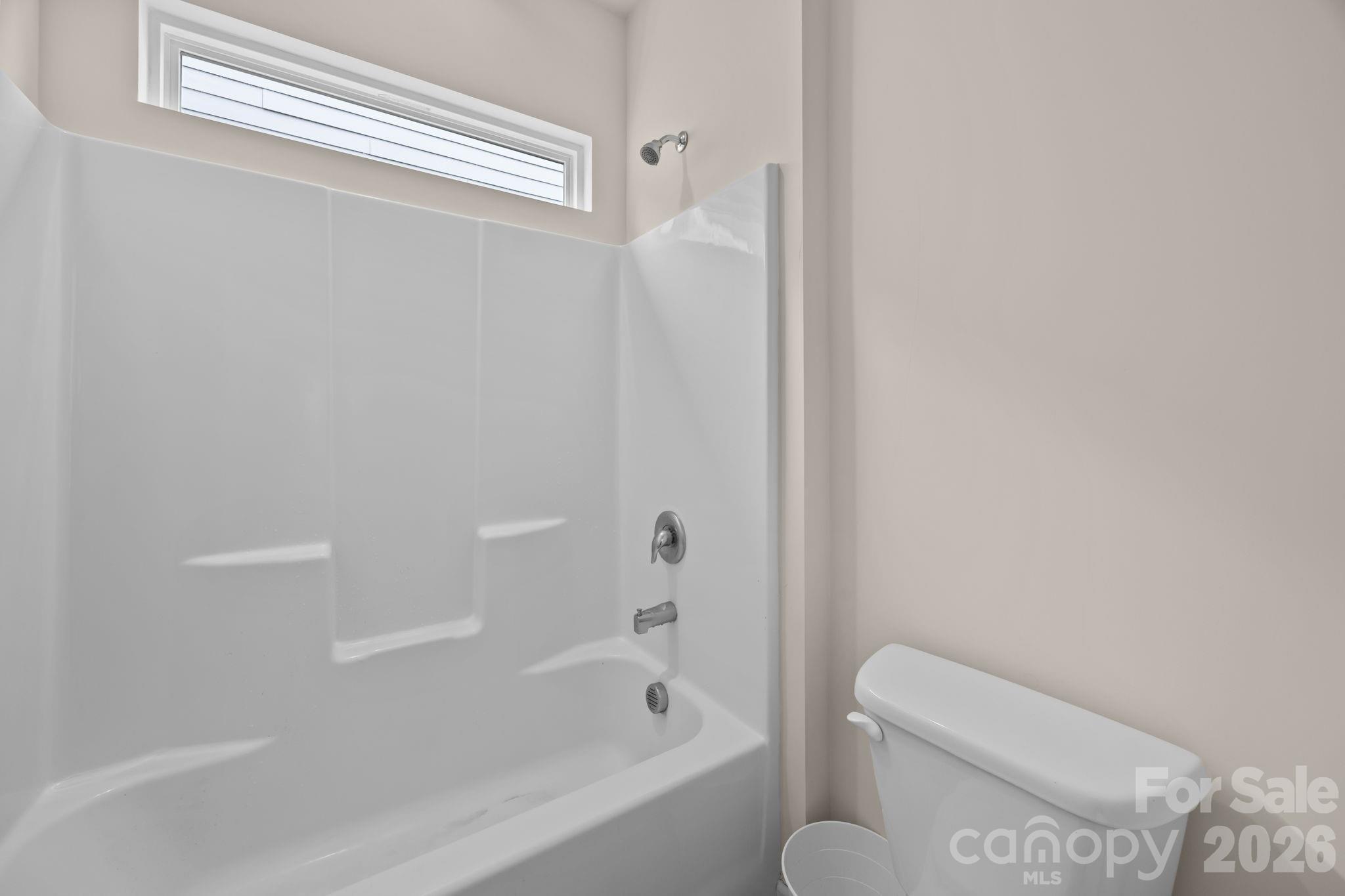 4028 Whittier Lane Tega Cay, SC 29708 - Photo 28 of 46 a bathroom with a toilet and bathtub