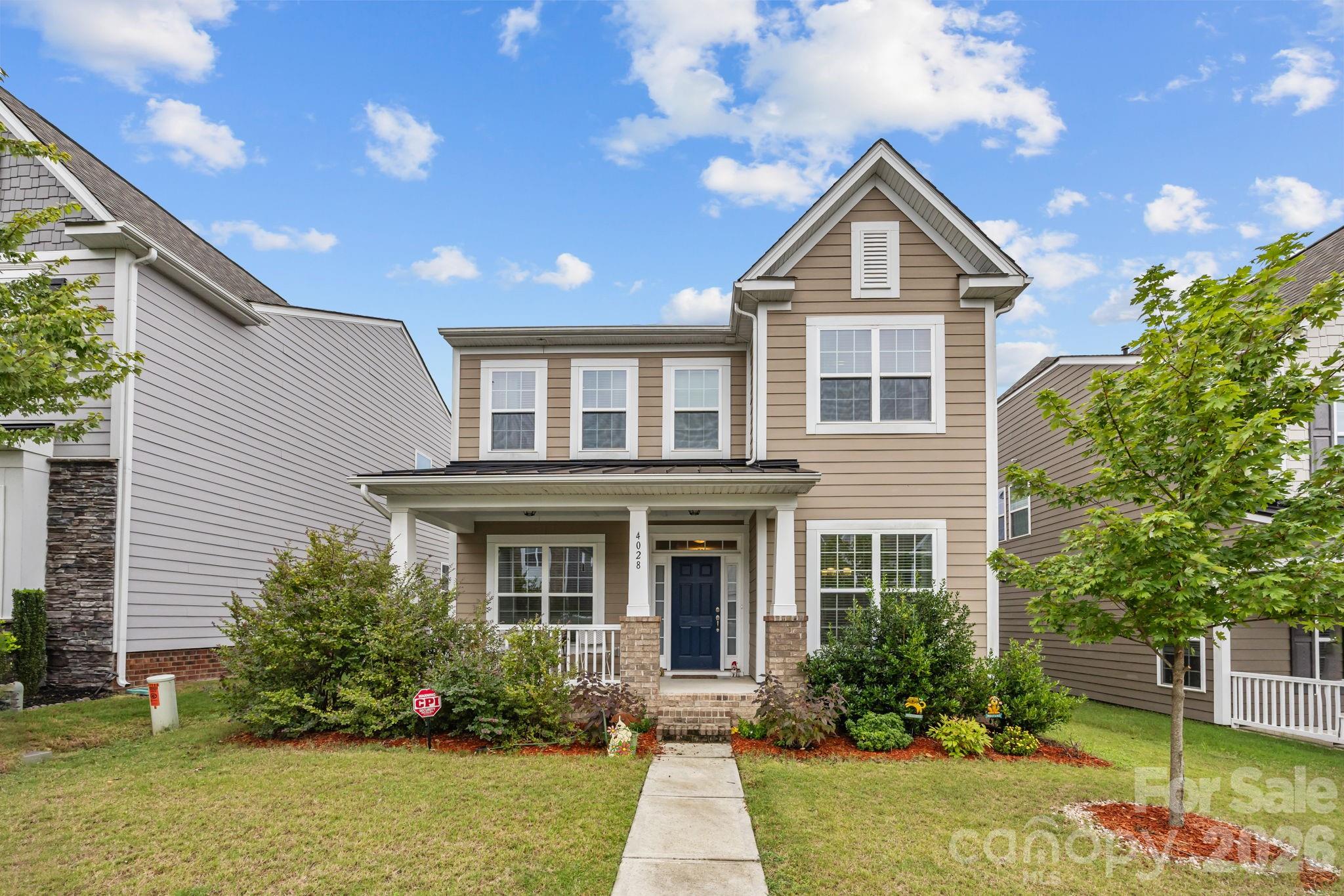 4028 Whittier Lane Tega Cay, SC 29708 - Photo 40 of 46 a front view of a house with garden