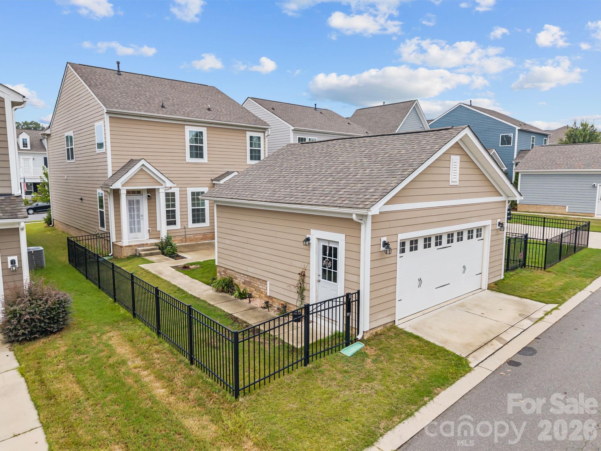 4028 Whittier Lane Tega Cay, SC 29708 - Photo 41 of 46 a view of house with garden and tall windows