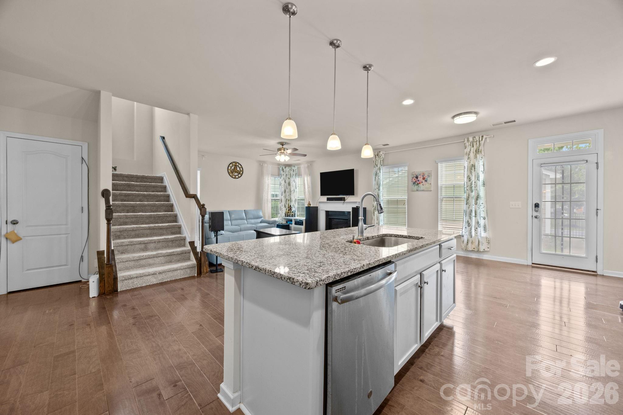 4028 Whittier Lane Tega Cay, SC 29708 - Photo 8 of 46 a kitchen with stainless steel appliances granite countertop a stove and a wooden floor
