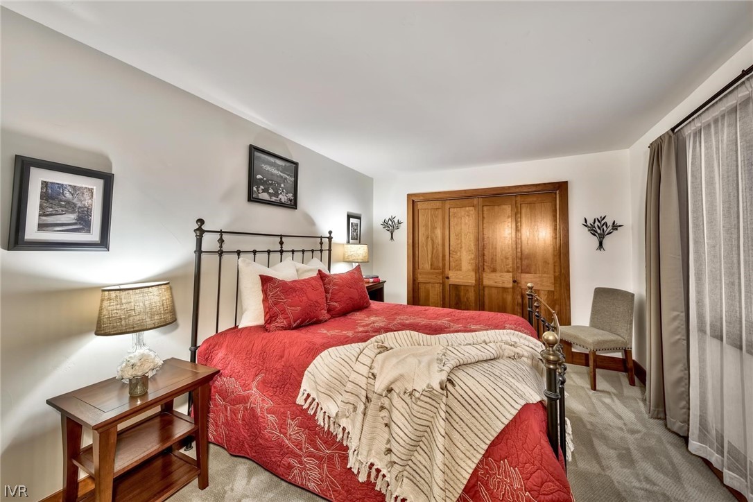 751 Tyner Way Incline Village, NV 89451 - Photo 20 of 29 a bedroom with a bed a mirror and lamp