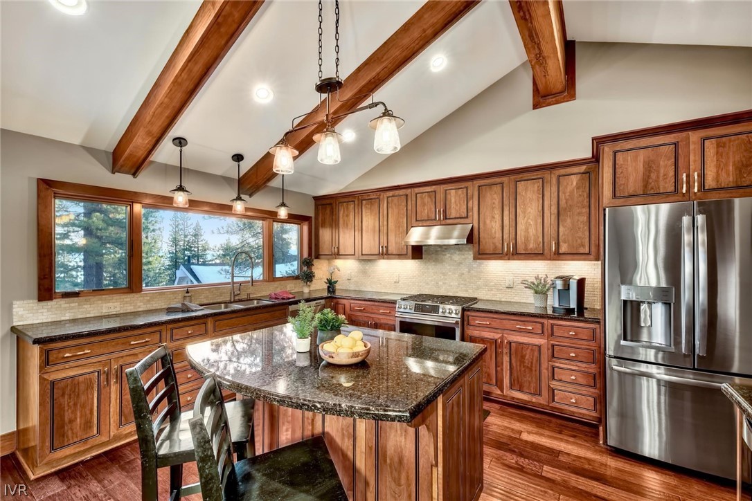 751 Tyner Way Incline Village, NV 89451 - Photo 6 of 29 a kitchen with stainless steel appliances granite countertop a kitchen island hardwood floor sink stove dining table and chairs
