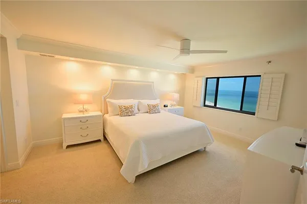 a view of a bedroom with bed and window