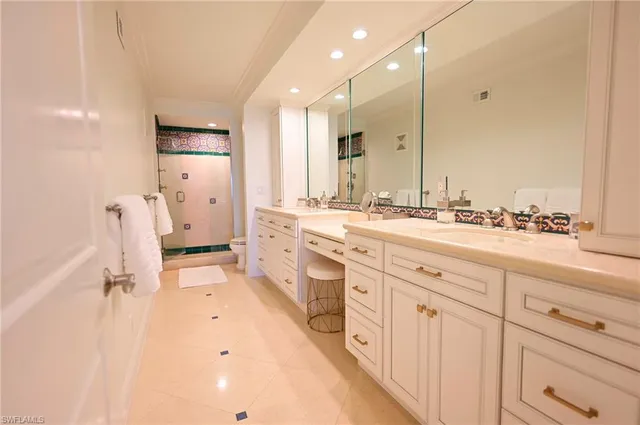 a spacious bathroom with a double vanity sink mirror and
