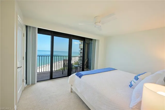 a bed sitting in a bedroom next to a balcony
