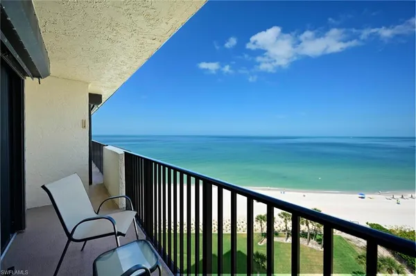 a balcony with view of a yard