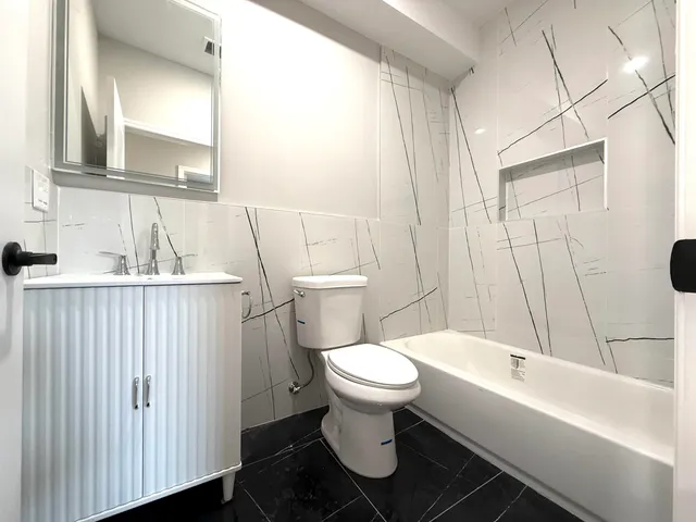 a bathroom with a toilet sink and bathtub