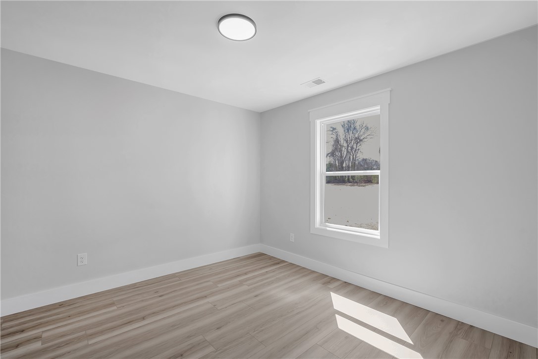2812 Smith McGee Road Iva, SC 29655 - Photo 12 of 26 Bright and airy, this room features expansive windows and durable flooring, perfect for versatile living.