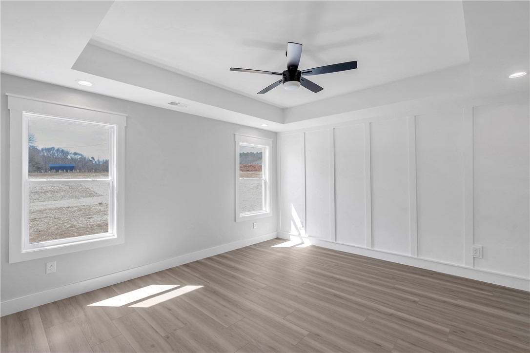 2812 Smith McGee Road Iva, SC 29655 - Photo 18 of 26 This airy bedroom features abundant natural light and modern design elements for comfortable living.