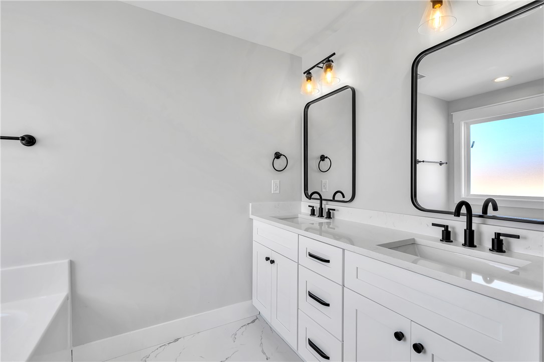 2812 Smith McGee Road Iva, SC 29655 - Photo 20 of 26 This modern bathroom features clean lines and a spacious double vanity with sleek black fixtures.