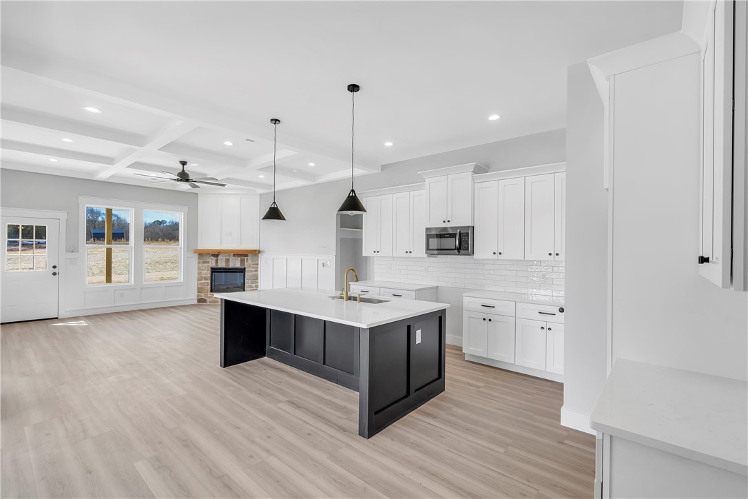 2812 Smith McGee Road Iva, SC 29655 - Photo 5 of 26 This bright, open concept living space features a kitchen island and a cozy fireplace.