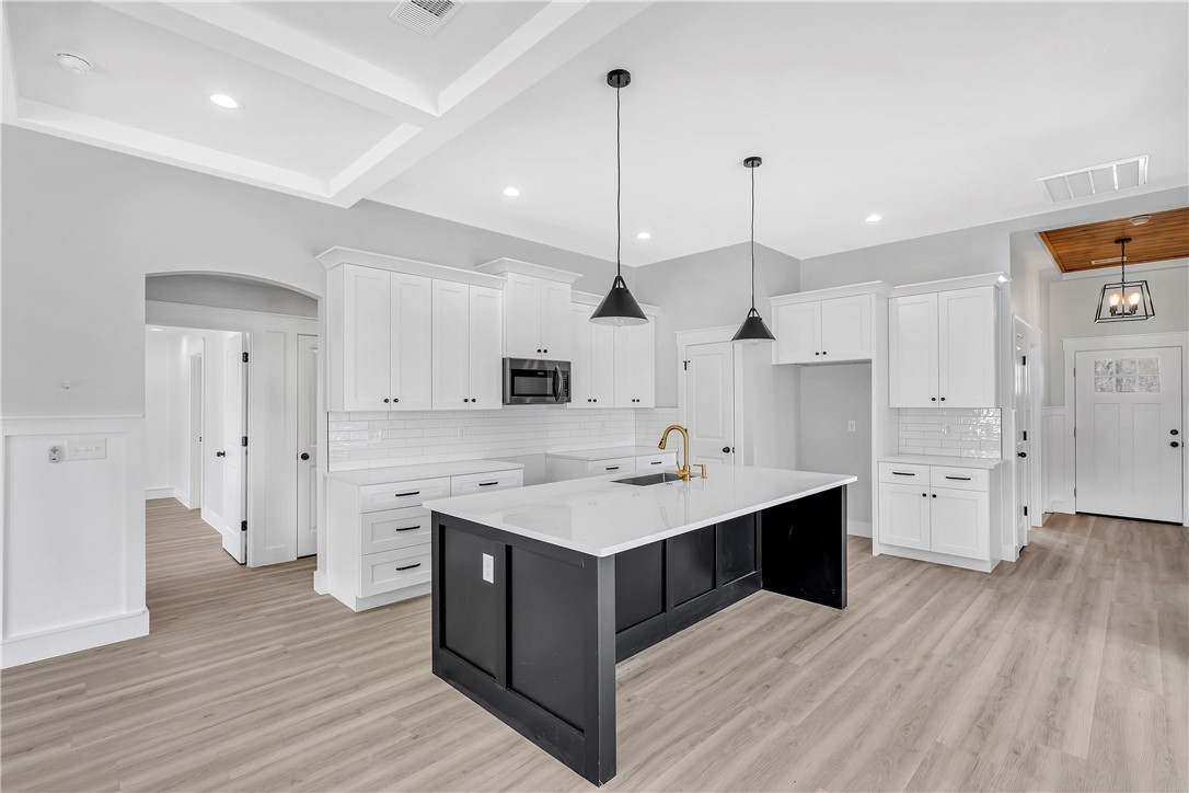 2812 Smith McGee Road Iva, SC 29655 - Photo 6 of 26 This kitchen features a central island, recessed lighting, and ample cabinetry, offering both style and functionality.
