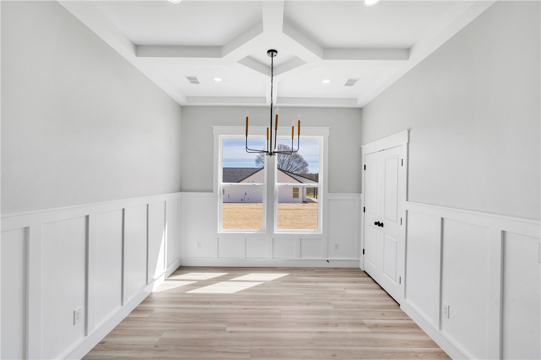 2812 Smith McGee Road Iva, SC 29655 - Photo 9 of 26 This bright room features sophisticated wainscoting, an elegant tray ceiling, and durable hardwood flooring.