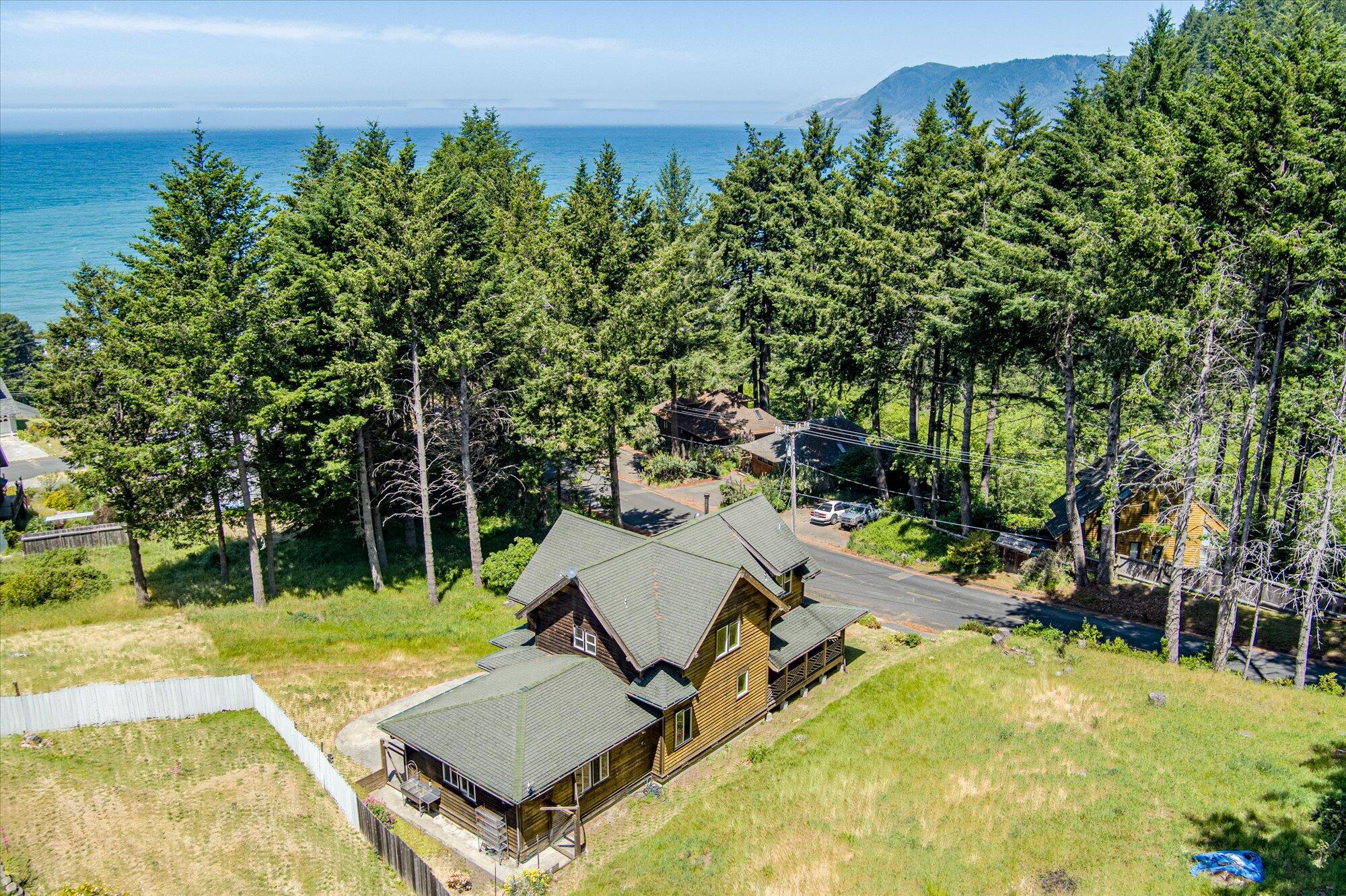 758 Beach Road Shelter Cove, CA 95589 - Photo 1 of 2 an aerial view of a house with swimming pool and garden