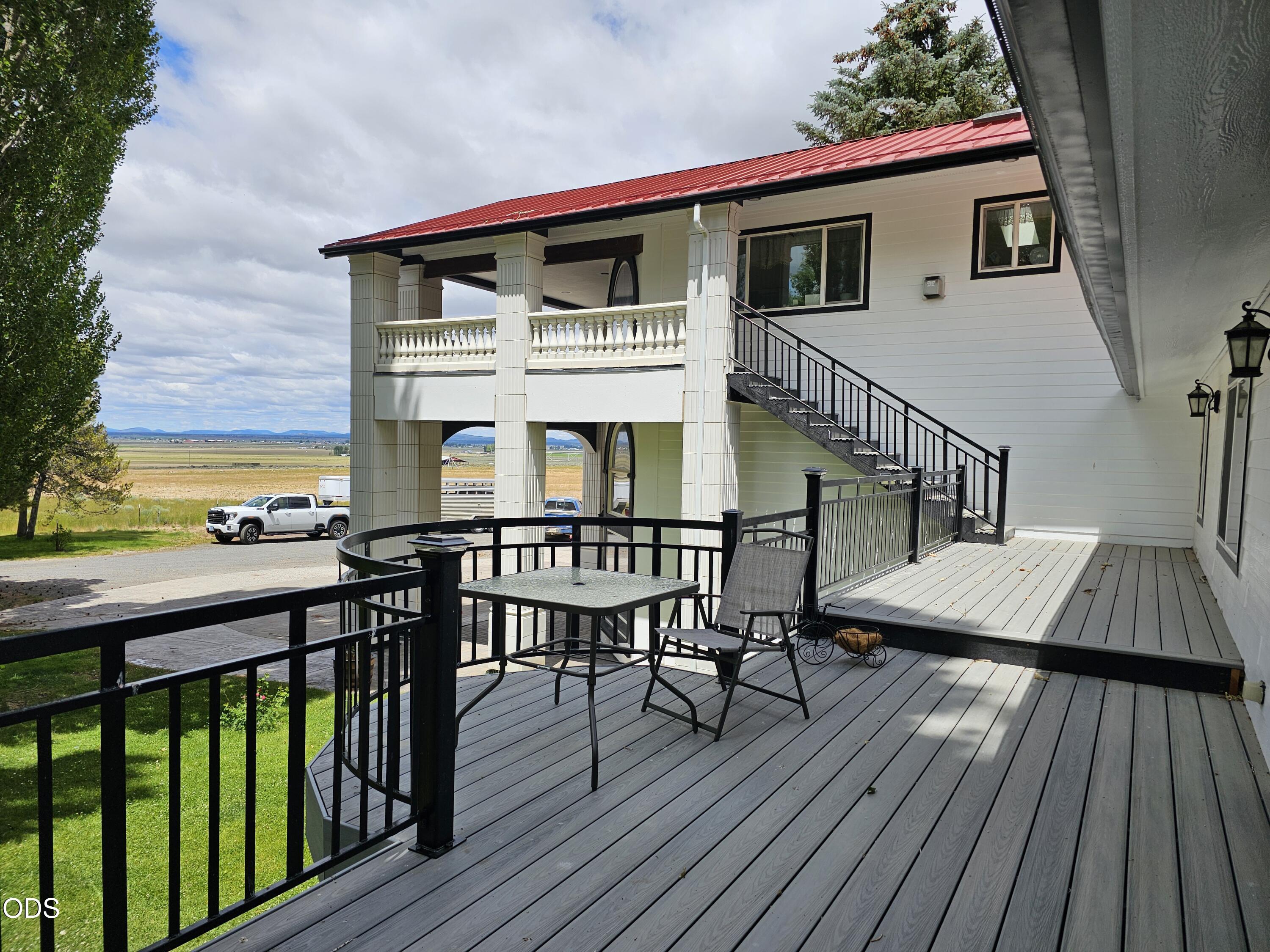 59047 Old Lake Road Christmas Valley, OR 97641 - Photo 65 of 68 a view of a roof deck with table and chairs with wooden floor and fence